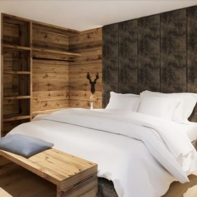Camera da letto in stile rustico con pareti in legno e arredamento accogliente. Camera da letto in stile rustico con pareti in legno e arredamento accogliente.